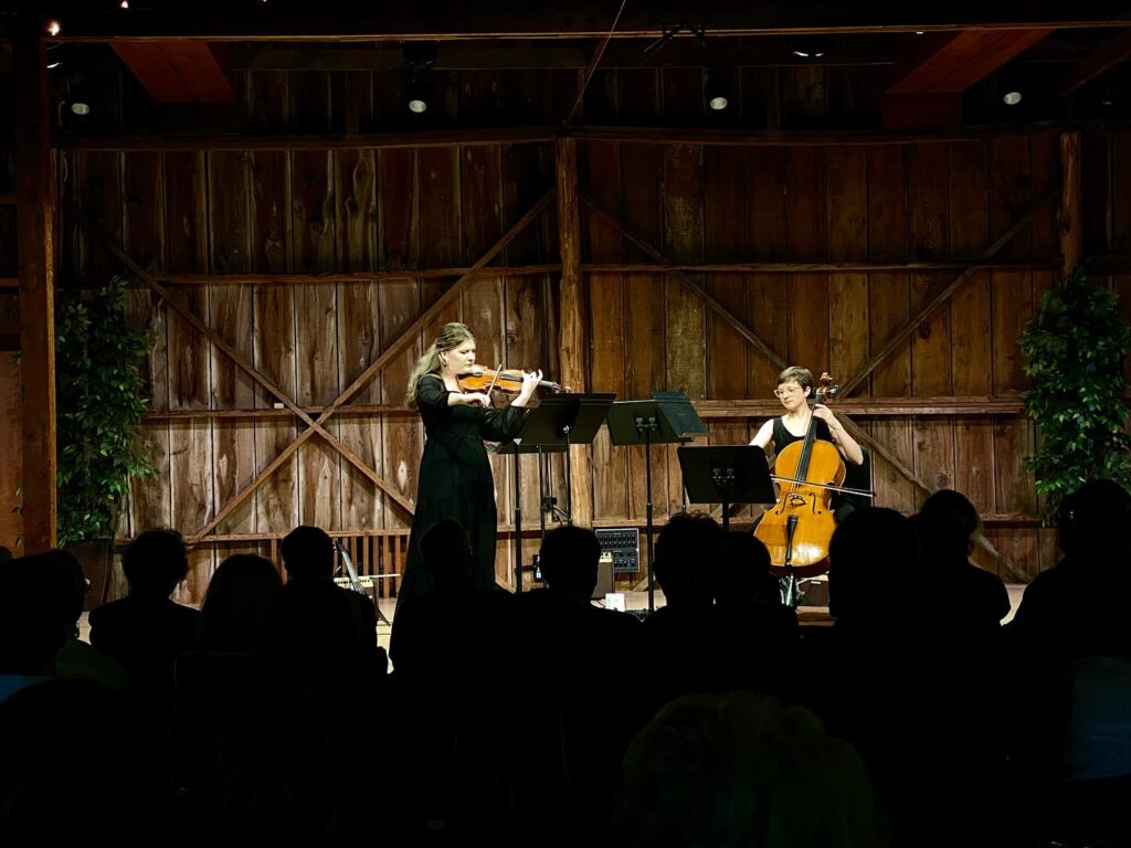 Two violinists on stage.